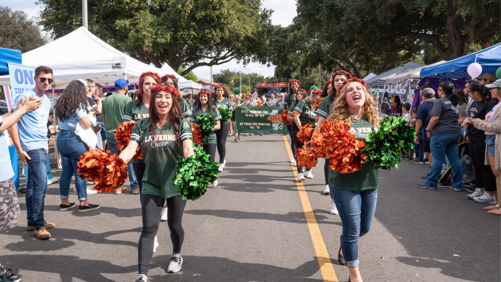Two women cheering during the 2019 Homecoming parade