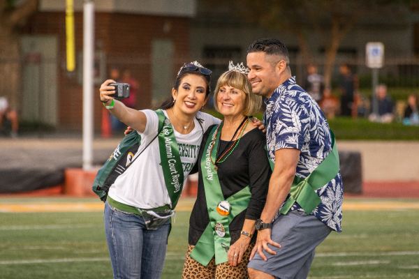 Group of ULV alumni taking a selfie at the Homecoming football game