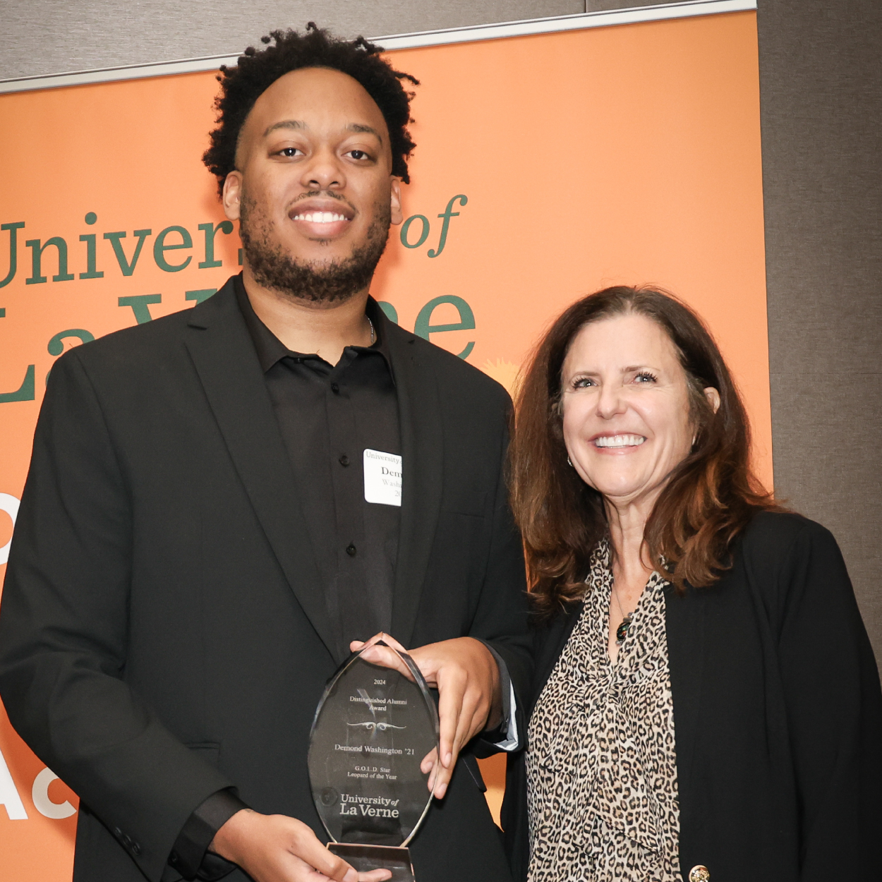 2023 Alumni Award winner Demond Washington with interim university president Risa Dickson.