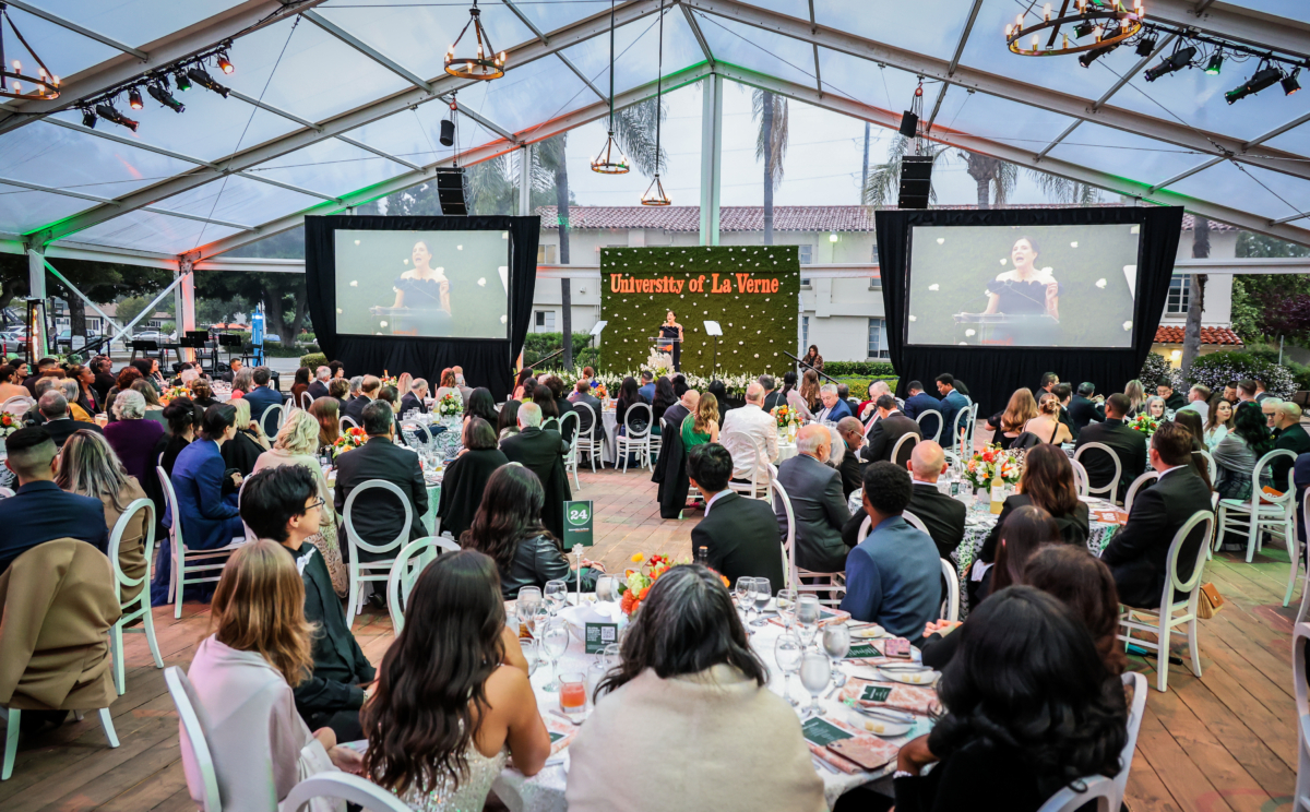 Attendees sitting at the Scholarship Gala watching President Risa Dickson speak.