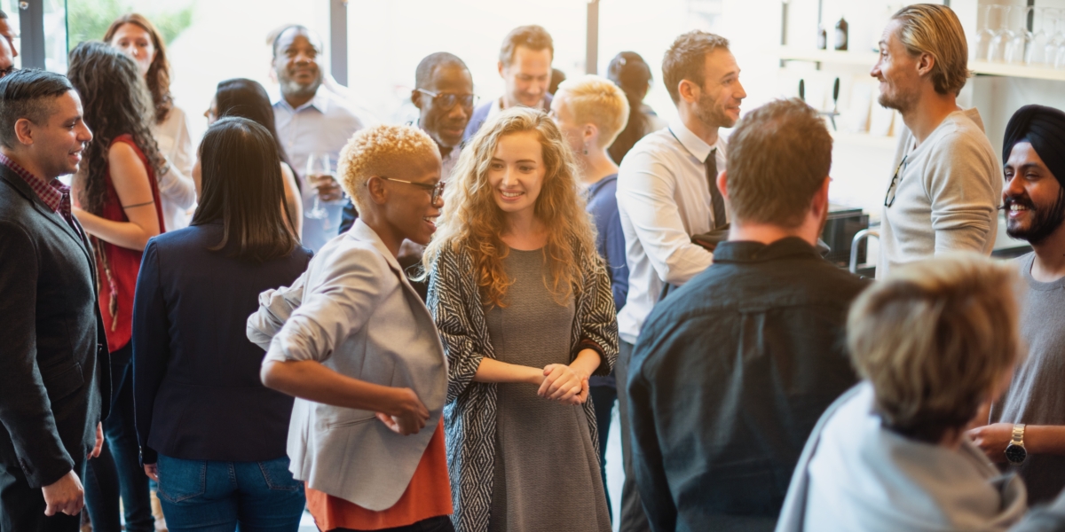 Group of people networking at an event.