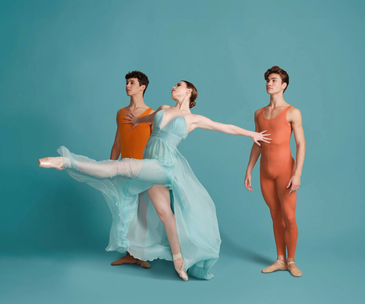 Ballet dancers against a blue background.