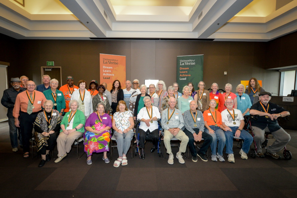Group of guests posing together with president Risa Dickson at the Golden Leopard Society luncheon.